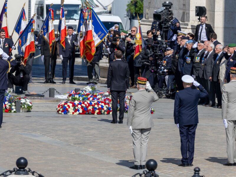 A wide shot of French President Emmanuel Macron, seen from behind, paying his respects at the Tomb of the Unknown Soldier after laying a wreath during the commemorative ceremony marking the 81st anniversary of Victory Day in 1945, at the Arc de Triomphe on Place de l’Etoile in Paris, France, on May 8, 2026. (Benjamin Vodant / Hans Lucas via AFP)